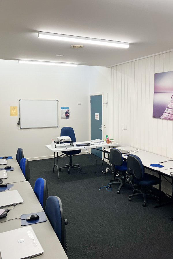 Computer room set up with desks and laptops