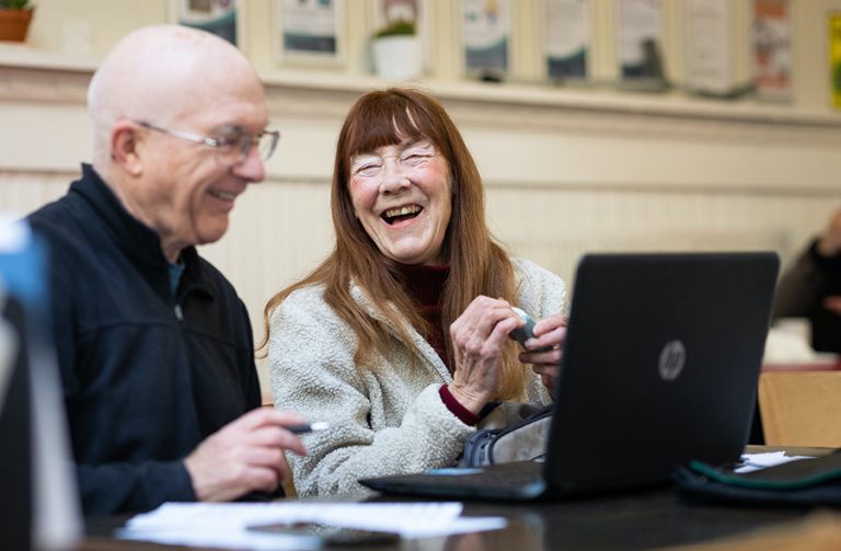 Two adult students learning Word and Excel in computer class