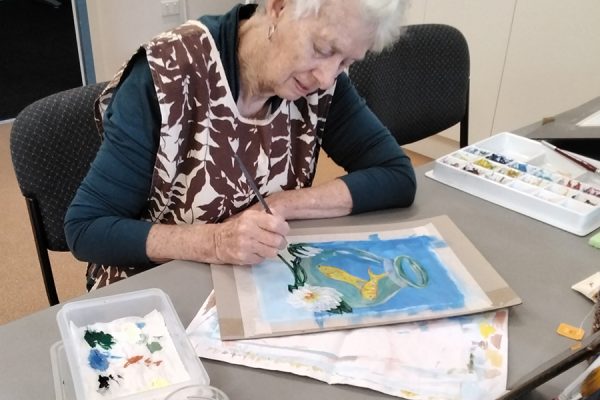 Woman painting colourful artwork