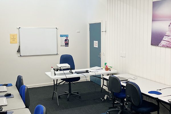 Computer room set up with desks and laptops