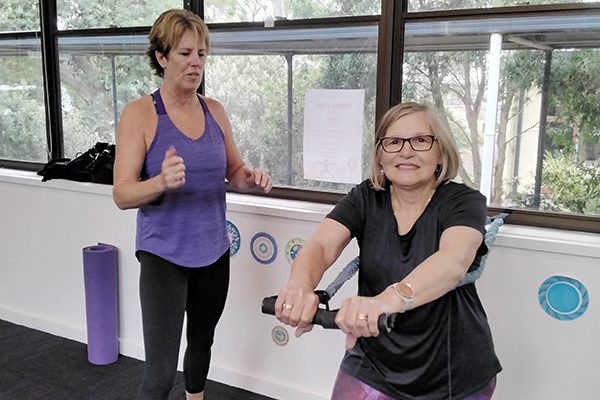 Woman being encouraged by instructor in Strong People Stay Young fitness class