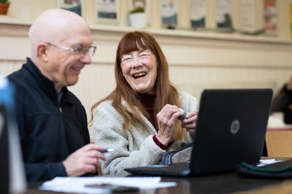 Two adult students learning Word and Excel in computer class