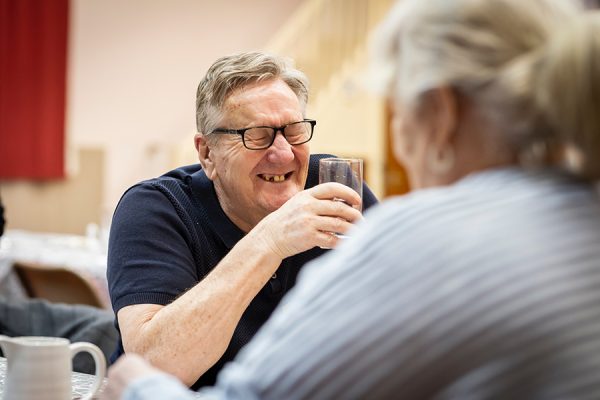 Man and woman laughing together in laughter for wellbeing program