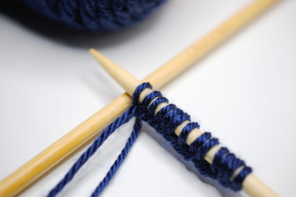 Knitting needles resting on table